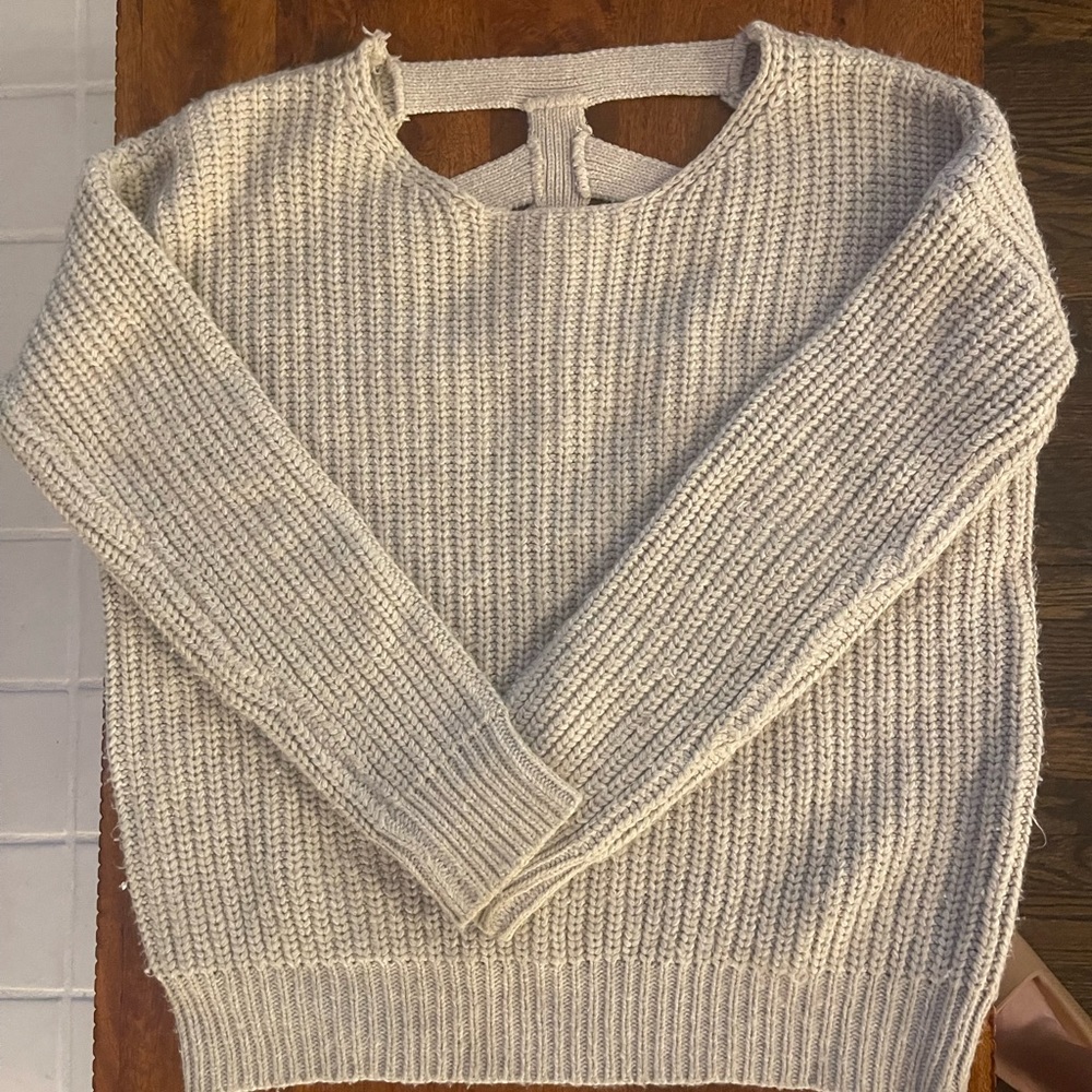 Beige oversized sweater with cutout detail in the back. Size small